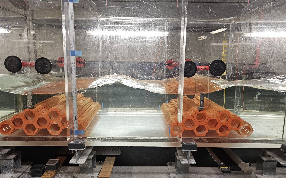 Two nine-unit SEAHIVE arrays in series in the wave flume, with a wave passing over both